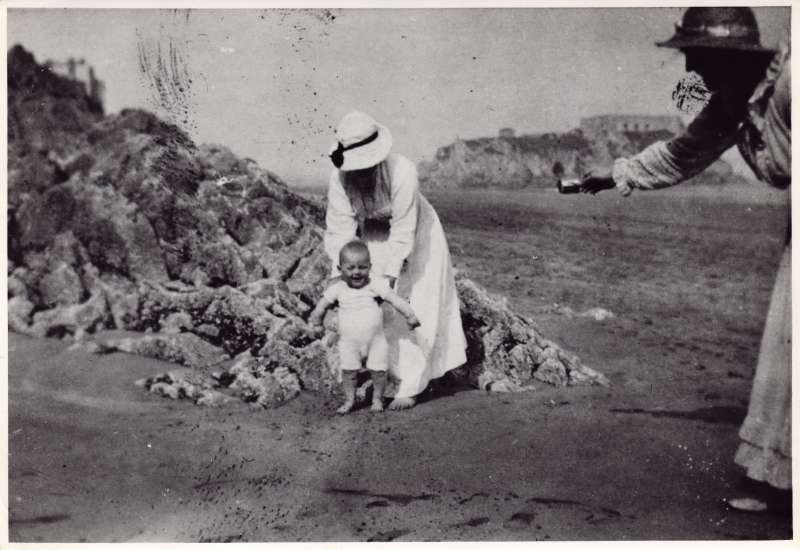 Leonard Cheshire as a toddler on the beach with two women