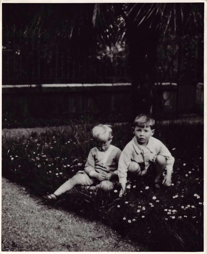 Leonard and Christopher Cheshire as young boys sat in a patch of flowers