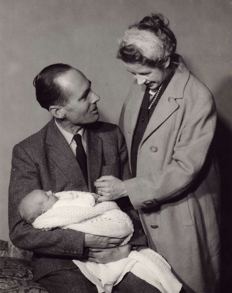 Posed shot of Leonard Cheshire holding a newborn Jeromy, with Sue Ryder standing over them
