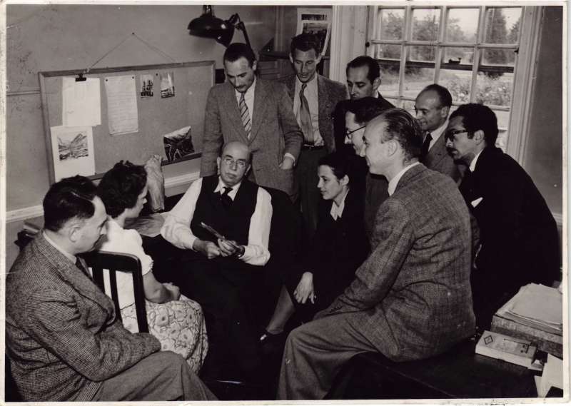 Several people in a room holding a meeting
