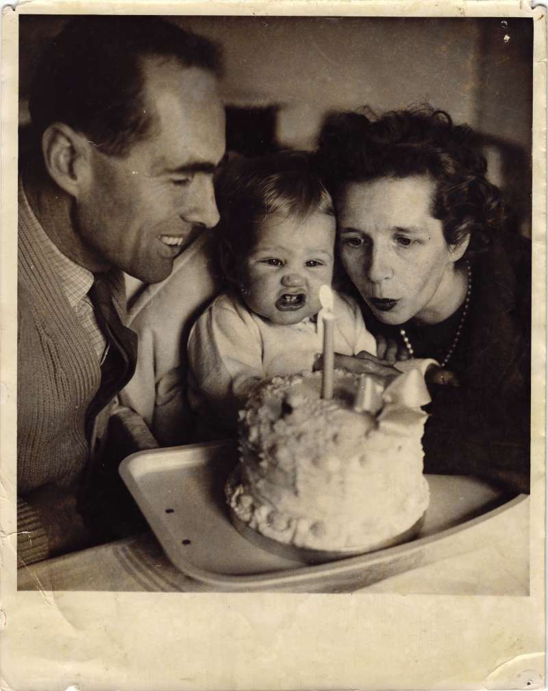 Sue Ryder and Leonard Cheshire with a young Jeromy between them blowing out a candle on a cake