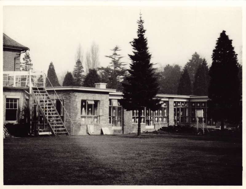 Photo of the back of the St Cecilia's building and the lawns and trees