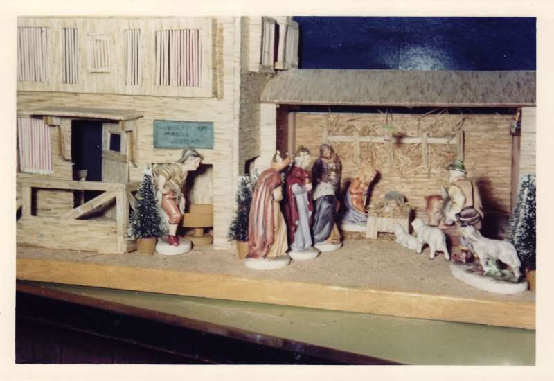 Close up shot of a crib and stable Christmas scene made from matchsticks, with model animals and people