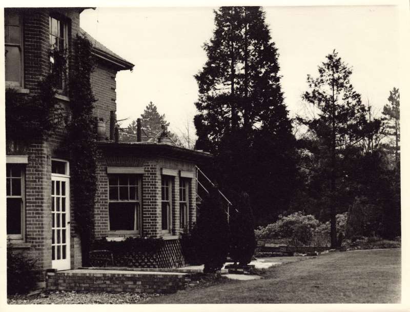 Photo of the back doorway, windows and gardens at St Cecilia's